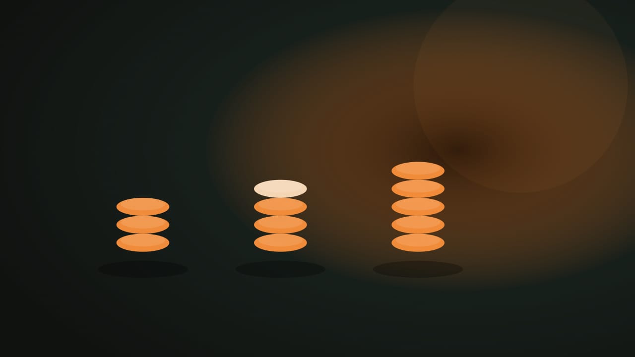 Three orange token piles on a dark table, one pile already partly taken