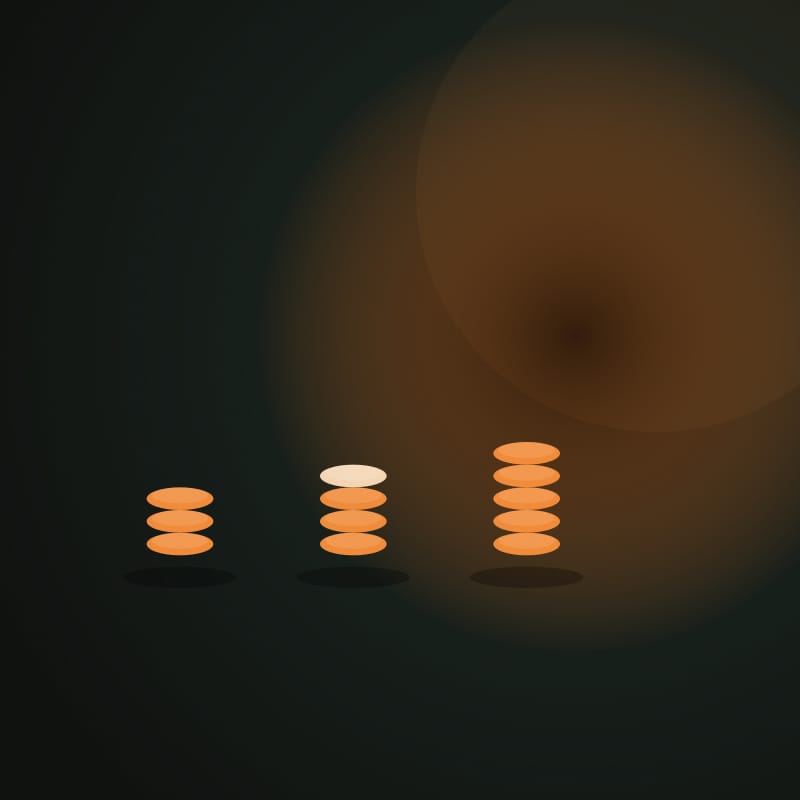 Three orange token piles on a dark table, one pile already partly taken