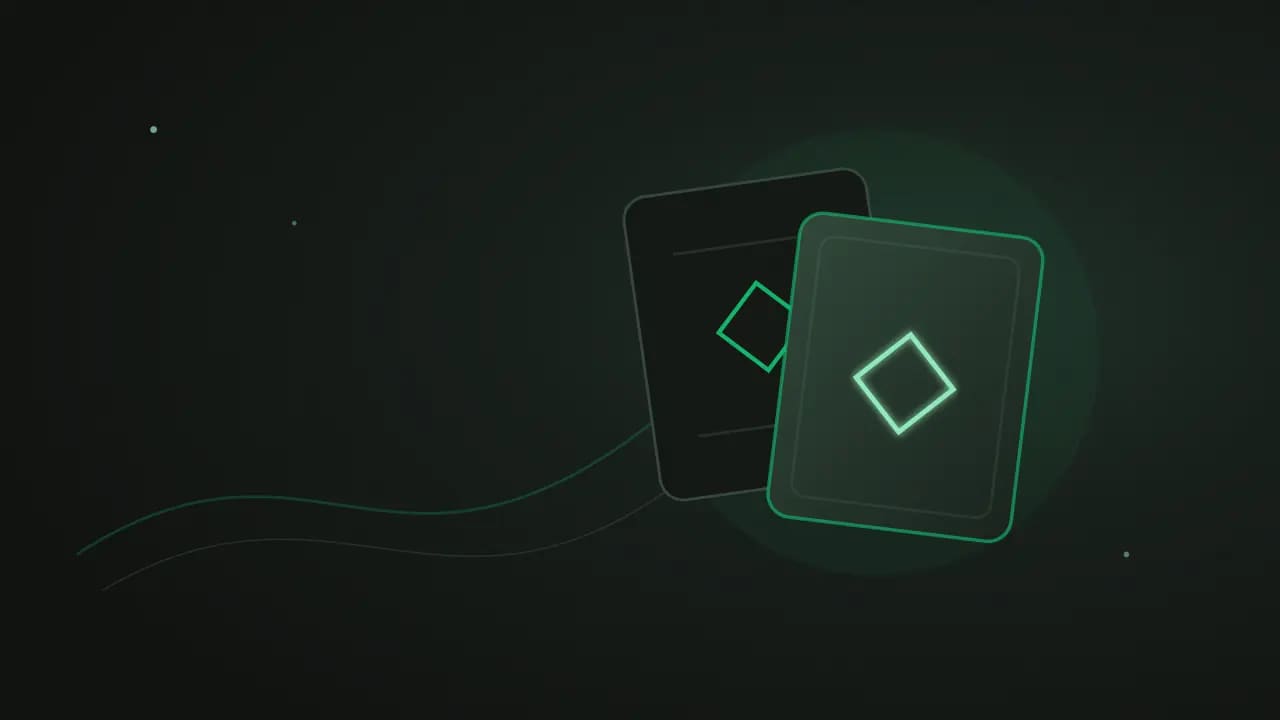 Two overlapping dark cards marked with matching emerald diamonds
