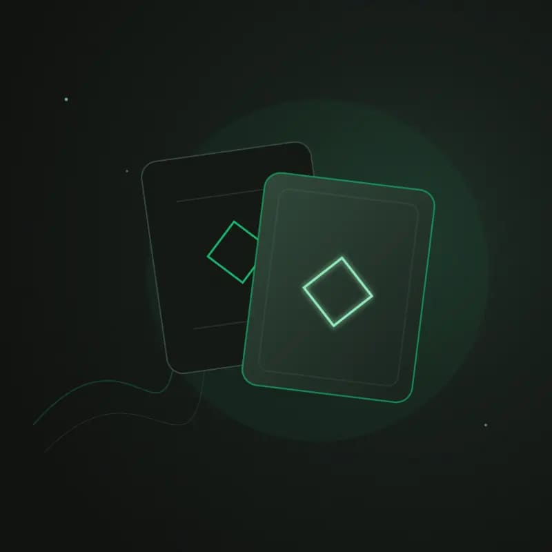 Two overlapping dark cards marked with matching emerald diamonds