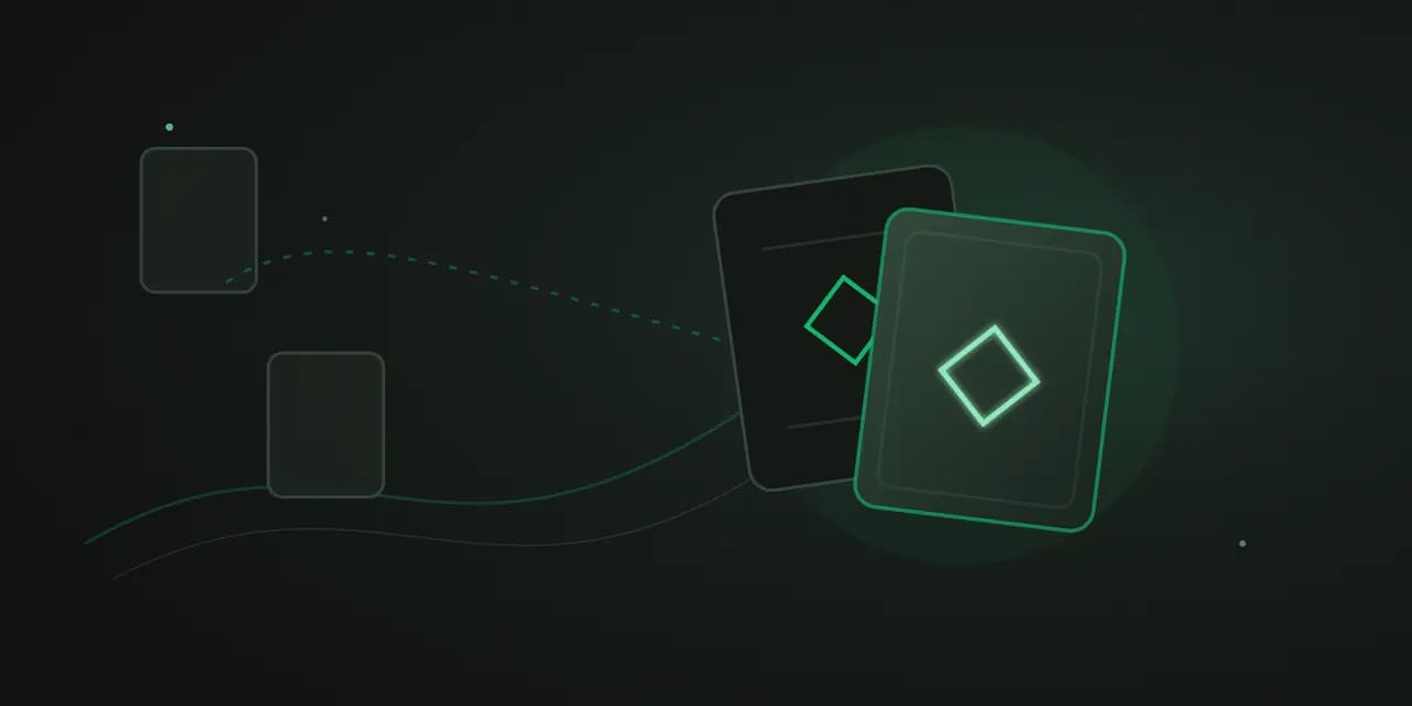Two overlapping dark cards marked with matching emerald diamonds